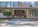Home featuring a covered entry and custom double doors with sidelight windows at 505 River Valley Rd, Sandy Springs, GA 30328