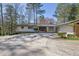 Charming home featuring a brick facade, a spacious driveway, and a two-car garage at 505 River Valley Rd, Sandy Springs, GA 30328