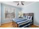 Blue bedroom with wood floors, double windows, and ceiling fan at 2678 Bonaire Ter, Marietta, GA 30066