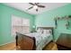 Light green bedroom with hardwood floors and double window at 2678 Bonaire Ter, Marietta, GA 30066