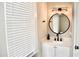 Modern bathroom with a round mirror and white vanity at 531 Connally St, Atlanta, GA 30312