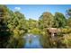 Serene pond with fountain, surrounded by lush trees and a wooden deck at 531 Connally St, Atlanta, GA 30312