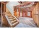 Unfinished basement with wooden staircase and framing at 4361 River Vista Rd, Ellenwood, GA 30294