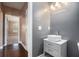 Modern bathroom with pedestal sink and gray walls at 4361 River Vista Rd, Ellenwood, GA 30294