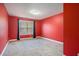 Empty bedroom with red walls and carpeted floors at 4361 River Vista Rd, Ellenwood, GA 30294