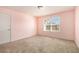 Spacious bedroom with pink walls and neutral carpeting at 4361 River Vista Rd, Ellenwood, GA 30294