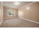 Bright bedroom with neutral carpeting and large window at 4361 River Vista Rd, Ellenwood, GA 30294