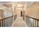 Elegant hallway with arched doorways and wood railing at 4361 River Vista Rd, Ellenwood, GA 30294