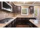 Spacious kitchen with granite countertops and dark wood cabinets at 4361 River Vista Rd, Ellenwood, GA 30294