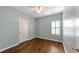 Simple bedroom with hardwood floors and a window at 615 Brookwater Dr, Stockbridge, GA 30281