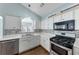 Clean kitchen with stainless steel appliances and white cabinetry at 615 Brookwater Dr, Stockbridge, GA 30281