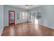 Bright sunroom featuring hardwood floors and a red door at 615 Brookwater Dr, Stockbridge, GA 30281