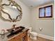 Basement bathroom with dark vanity and large mirror at 3959 Saint Elisabeth Sq, Duluth, GA 30096