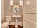 Elegant powder room with pedestal sink and classic fixtures at 3959 Saint Elisabeth Sq, Duluth, GA 30096