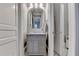Small powder room with gray vanity and marble-tiled floor at 3959 Saint Elisabeth Sq, Duluth, GA 30096