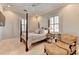 Bedroom with post bed, armchair, and window with plantation shutters at 3959 Saint Elisabeth Sq, Duluth, GA 30096