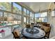 Bright sunroom with ample seating, overlooking the pool area at 3959 Saint Elisabeth Sq, Duluth, GA 30096