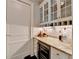 Convenient wet bar with wine cooler and granite countertop at 3959 Saint Elisabeth Sq, Duluth, GA 30096