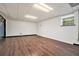 Unfinished basement with dark wood floors and a single window at 4141 Willow Ridge Rd, Douglasville, GA 30135