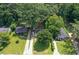 Aerial view of a cozy home with a long driveway nestled among lush green trees at 1256 Elizabeth Ave, Atlanta, GA 30310