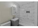 Updated bathroom featuring a modern vanity, stylish mirror, and tiled shower-tub combo at 1256 Elizabeth Ave, Atlanta, GA 30310