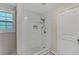 Tiled walk-in shower featuring white subway tile and updated shower fixtures at 1256 Elizabeth Ave, Atlanta, GA 30310