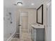 Bright bathroom boasts tiled walk-in shower and updated vanity and cabinets at 1256 Elizabeth Ave, Atlanta, GA 30310