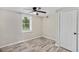 Neutral bedroom features light wood flooring, ceiling fan and natural light at 1256 Elizabeth Ave, Atlanta, GA 30310