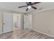 Neutral bedroom with ceiling fan, light wood floors and multiple doors at 1256 Elizabeth Ave, Atlanta, GA 30310