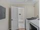 Convenient laundry room with washer and dryer, leading to a renovated bathroom at 1256 Elizabeth Ave, Atlanta, GA 30310