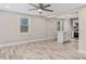 Open-concept living space featuring light wood floors and a modern ceiling fan at 1256 Elizabeth Ave, Atlanta, GA 30310