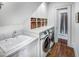 Bright laundry room with washer, dryer, and extra storage at 2583 Habersham Nw Rd, Atlanta, GA 30305