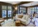 Living room features a white sofa, dark-painted walls, and access to a patio at 2583 Habersham Nw Rd, Atlanta, GA 30305