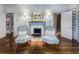 Sitting area with fireplace and two blue armchairs at 2583 Habersham Nw Rd, Atlanta, GA 30305