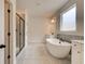 Elegant bathroom with soaking tub, double vanity, and walk-in shower at 508 Dolce Rd, Locust Grove, GA 30248