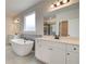 Spa-like bathroom featuring a freestanding tub and dual vanities at 508 Dolce Rd, Locust Grove, GA 30248