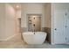 Bathroom features a large soaking tub and walk-in shower at 203 Arabella Pkwy, Locust Grove, GA 30248