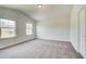 Cozy bedroom with natural light and plush carpeting, perfect for relaxing at 203 Arabella Pkwy, Locust Grove, GA 30248