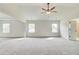 A neutral carpeted bedroom featuring natural light and plenty of space at 203 Arabella Pkwy, Locust Grove, GA 30248