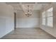 Formal dining room with hardwood floors, wainscoting, and a chandelier at 203 Arabella Pkwy, Locust Grove, GA 30248