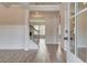 Inviting entryway featuring hardwood floors, wainscoting, and a staircase with iron balusters at 203 Arabella Pkwy, Locust Grove, GA 30248