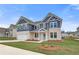 New construction home with a two-car garage, stone veneer, navy siding, and professional landscaping at 203 Arabella Pkwy, Locust Grove, GA 30248