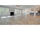 Open concept Gathering room with hardwood floors, fireplace and kitchen at 203 Arabella Pkwy, Locust Grove, GA 30248