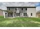 Gray house exterior with a covered patio and grassy backyard at 203 Arabella Pkwy, Locust Grove, GA 30248