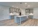 Modern kitchen with gray cabinets, white quartz countertops, and stainless steel appliances at 203 Arabella Pkwy, Locust Grove, GA 30248