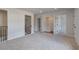 Upstairs landing with carpet flooring and access to laundry room at 203 Arabella Pkwy, Locust Grove, GA 30248