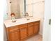 Double vanity with wood cabinets in bathroom at 2374 Suwanee Pointe Dr, Lawrenceville, GA 30043