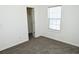 Bedroom with carpeted floor, window, and walk-in closet at 2374 Suwanee Pointe Dr, Lawrenceville, GA 30043