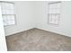 Bright bedroom with carpeted floors and two large windows at 2374 Suwanee Pointe Dr, Lawrenceville, GA 30043