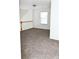 Spacious carpeted bedroom with a window and a view of the staircase at 2374 Suwanee Pointe Dr, Lawrenceville, GA 30043